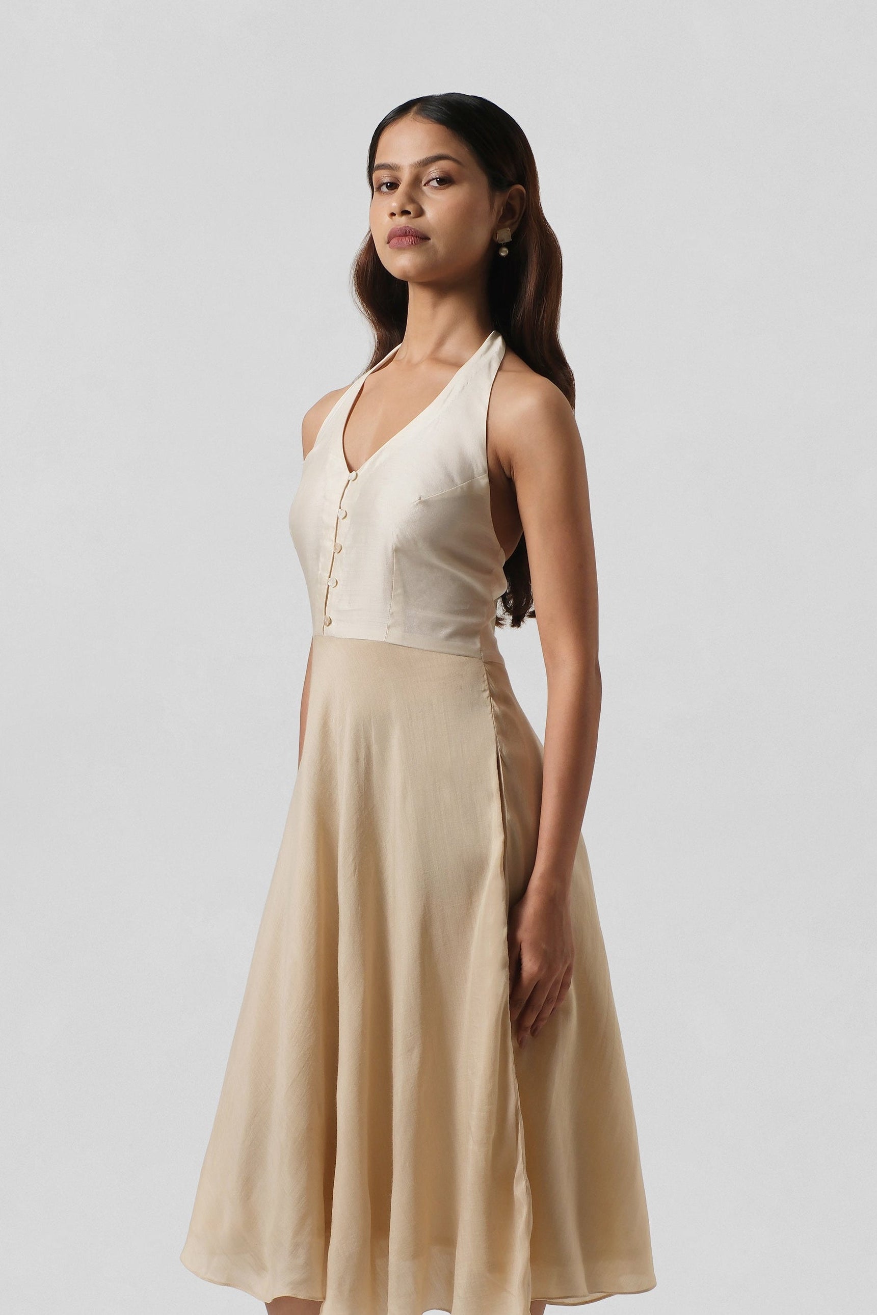 Front view of the House of Lore Diana Dress in black Chiniya and Muga silk featuring a deep V halter neckline, five-button front bodice and flowing A-line silhouette.