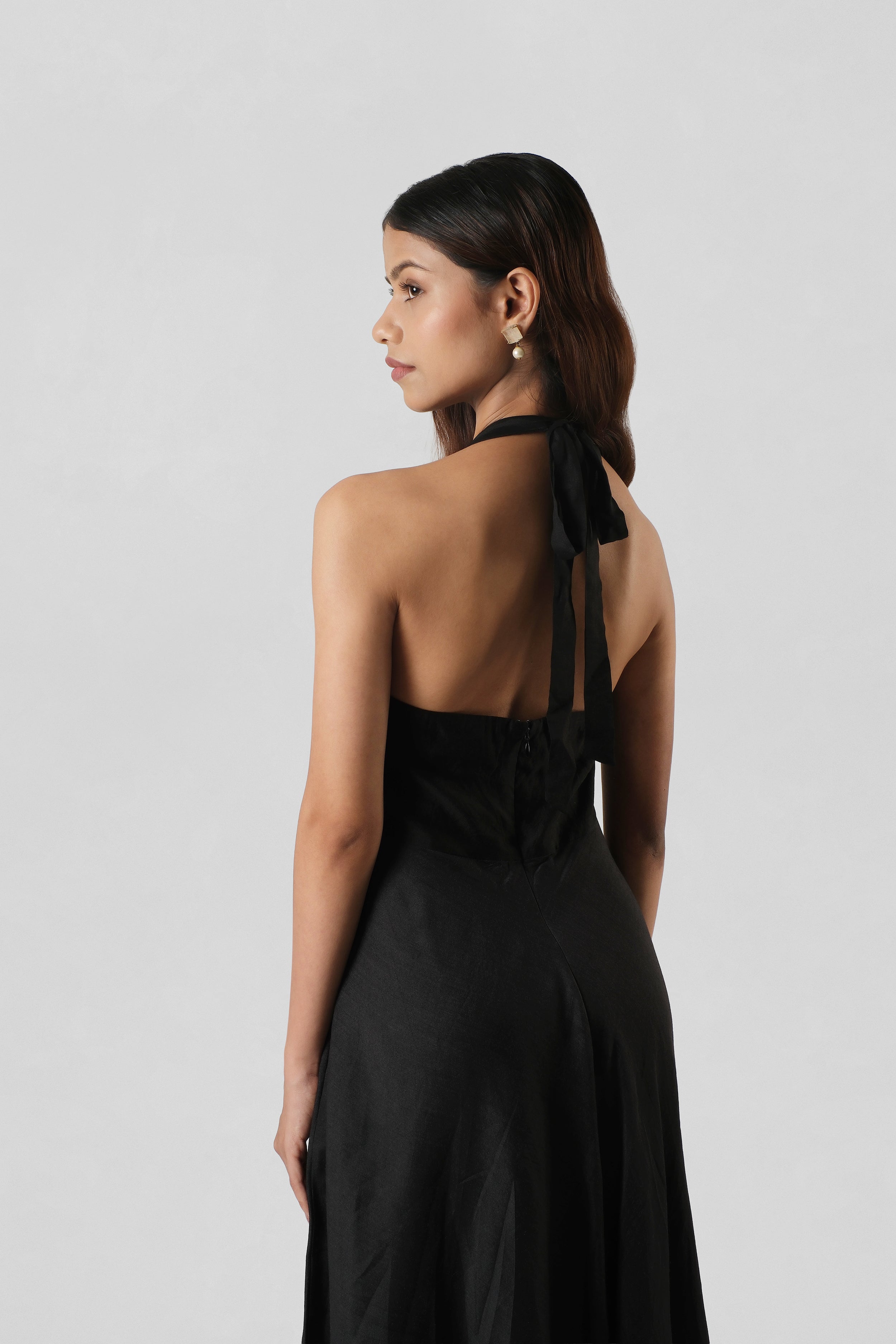 Back view of the Diana Black Silk Dress showcasing the elegant halter construction and fluid silhouette.