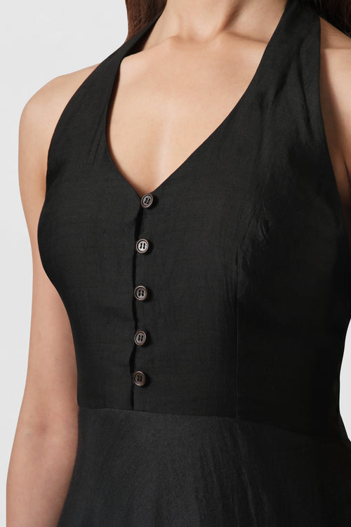Close-up of the Diana Black Silk Dress highlighting the handcrafted halter neckline and button-front bodice.