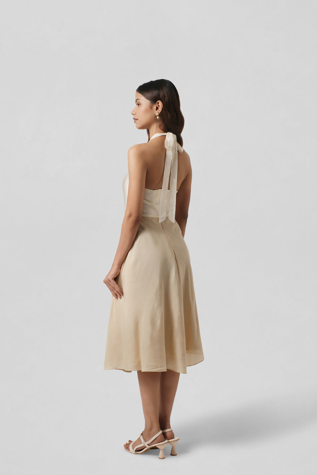 Back view of the Diana Gold Silk Dress highlighting its fluid A-line silhouette and graceful drape.