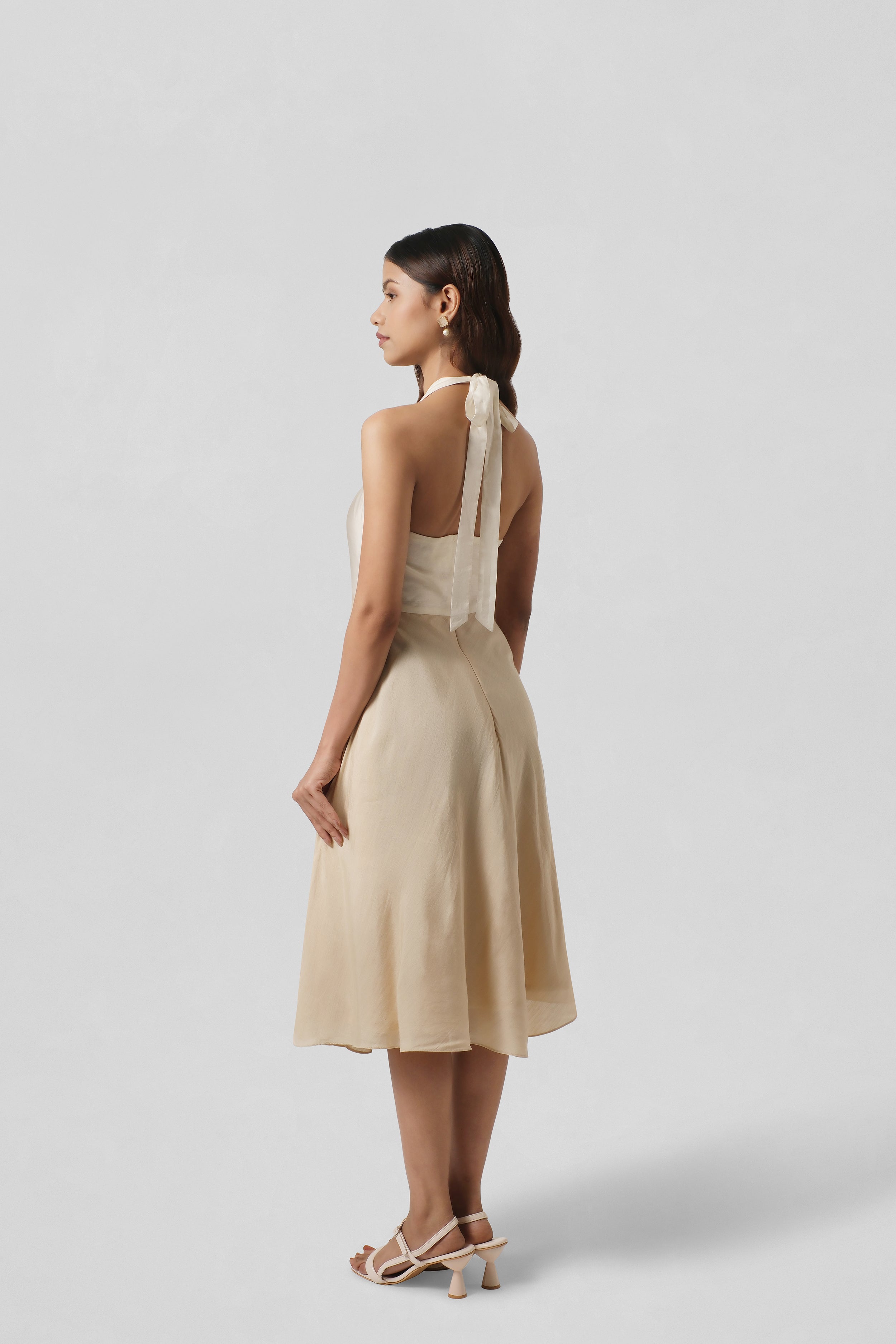 Back view of the Diana Gold Silk Dress highlighting its fluid A-line silhouette and graceful drape.