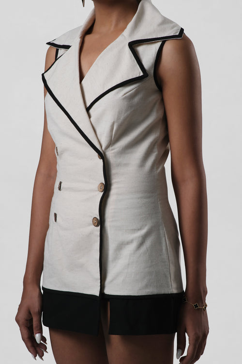 Close-up of the Amelia Dress highlighting the architectural lapel collar, button detailing, and structured tailoring.