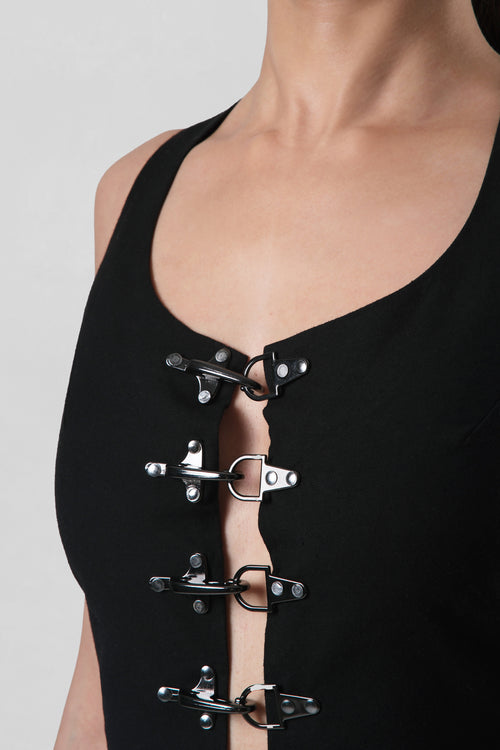 Close-up of the Frida Top highlighting the gunmetal buckle front closures and tailored linen construction.