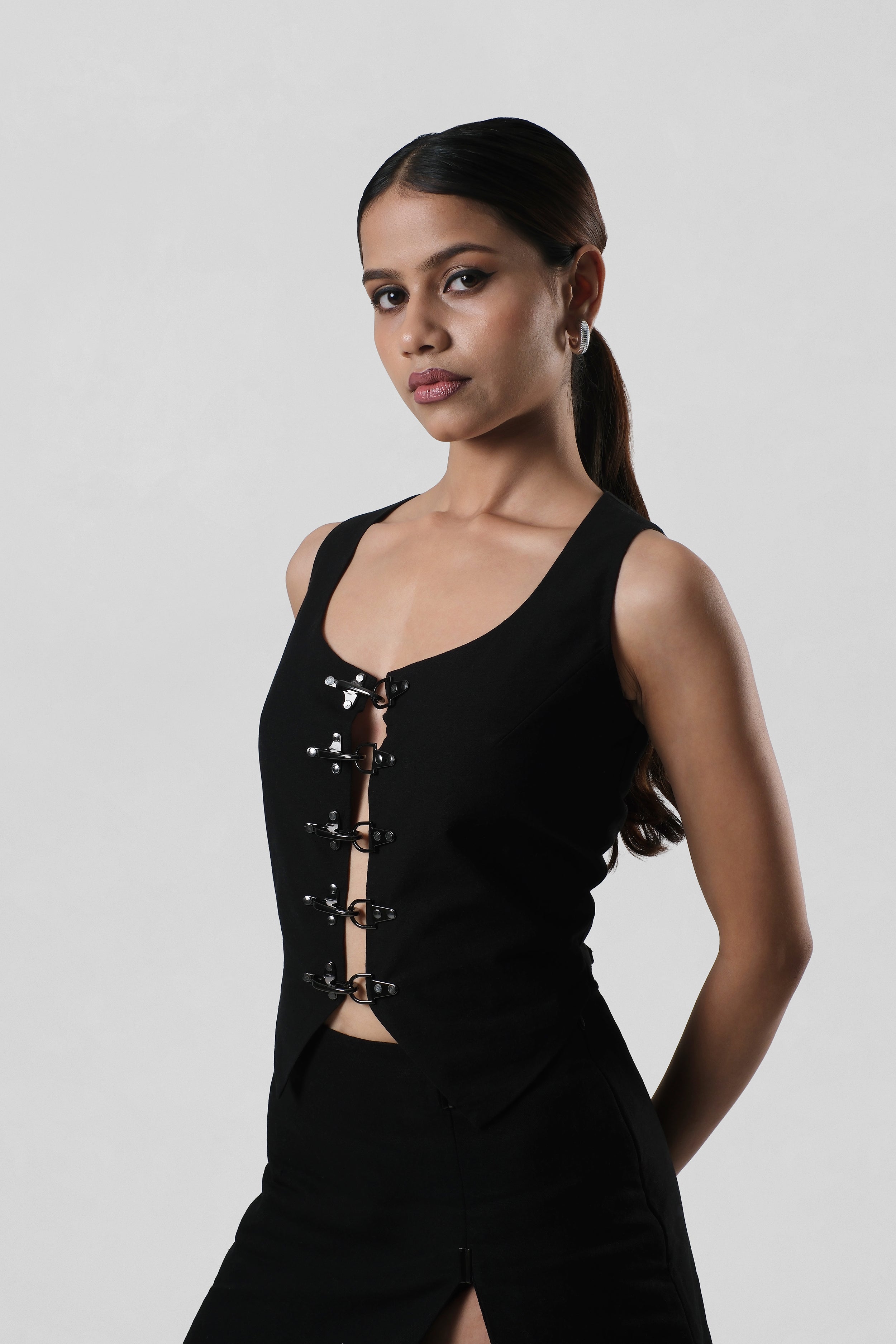 Three-quarter view of the Frida Top showcasing its sculpted fit and contemporary sleeveless silhouette.