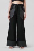Jane Trousers in black crafted from cotton canvas with cactus leather detailing, featuring a high-waisted wide-leg silhouette.