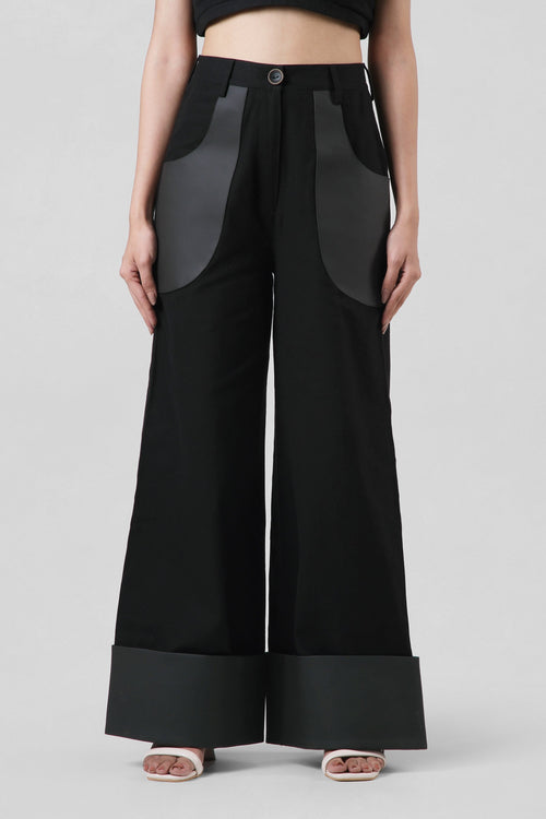 Jane Trousers in black crafted from cotton canvas with cactus leather detailing, featuring a high-waisted wide-leg silhouette.