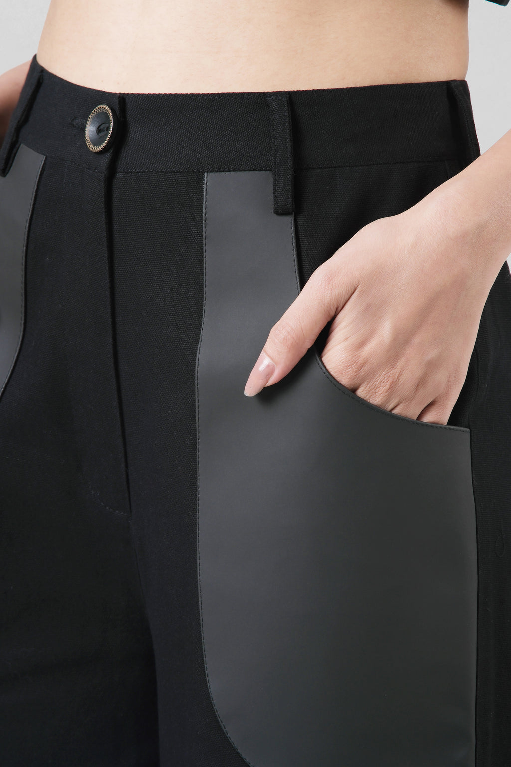 Close-up of the Jane Trousers highlighting the cactus leather pocket detailing and structured cotton canvas construction.