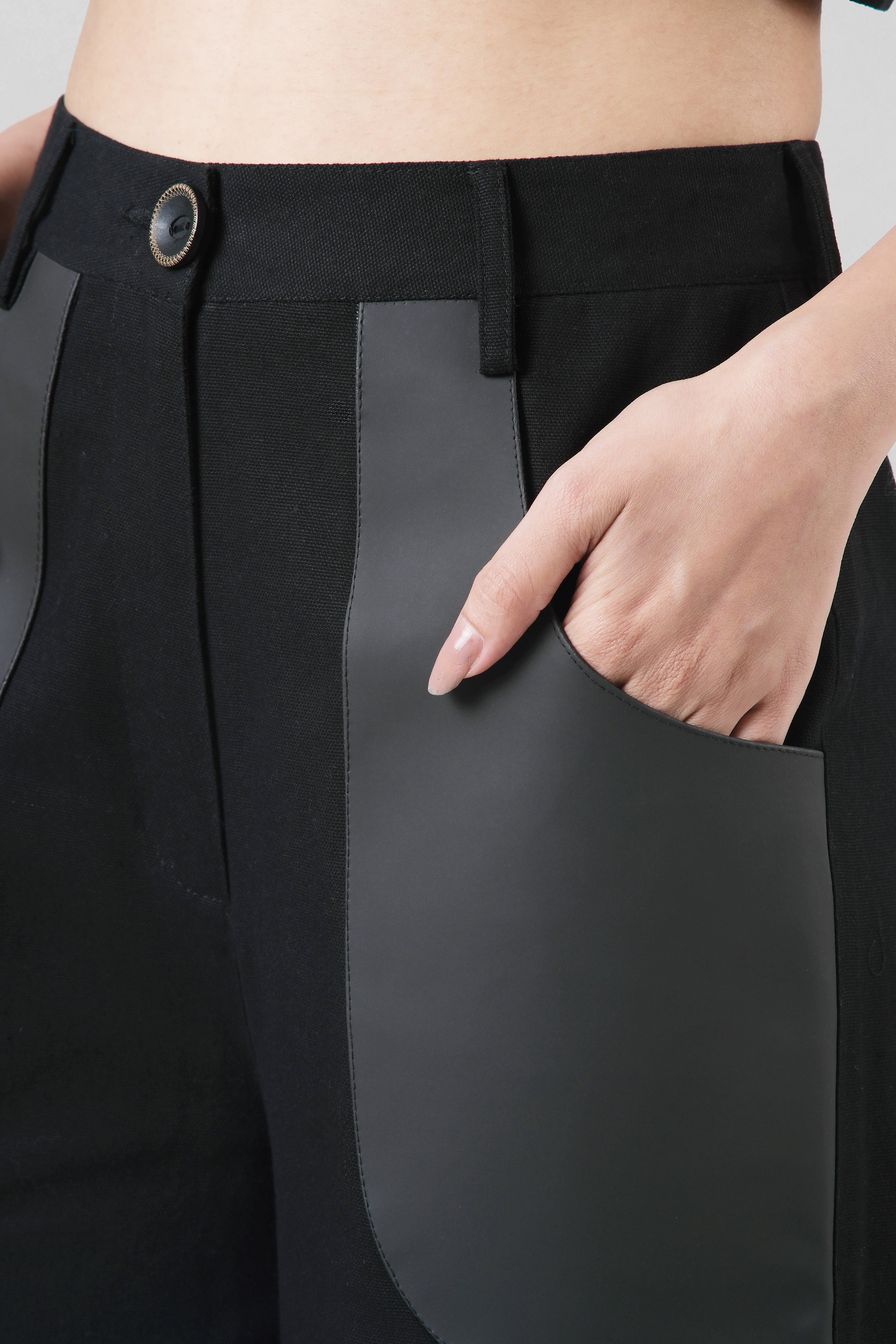 Close-up of the Jane Trousers highlighting the cactus leather pocket detailing and structured cotton canvas construction.