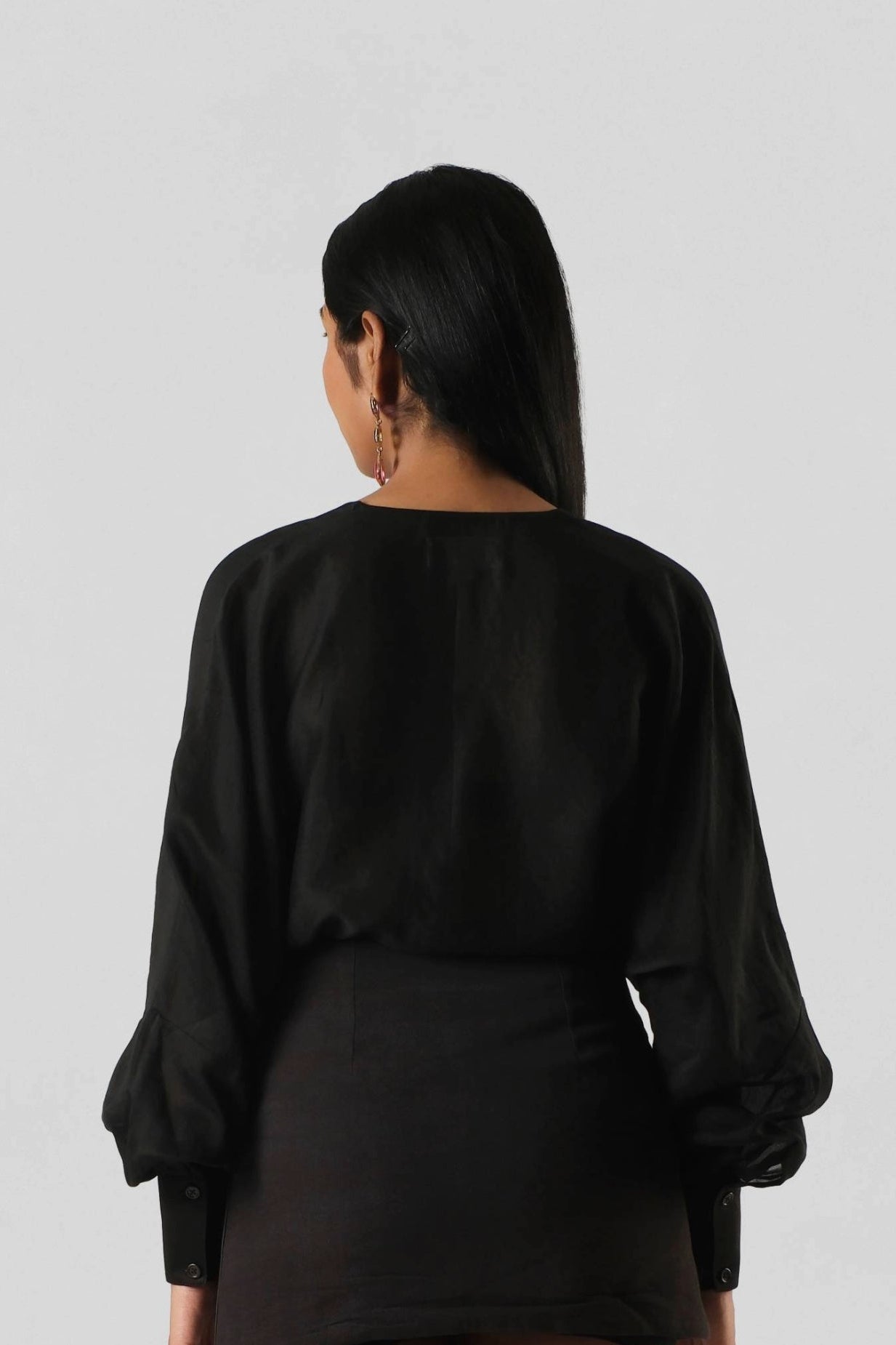 Back view of the RiRi Co-ord displaying the fluid Chanderi drape and structured cactus leather skirt for a contemporary luxury look.