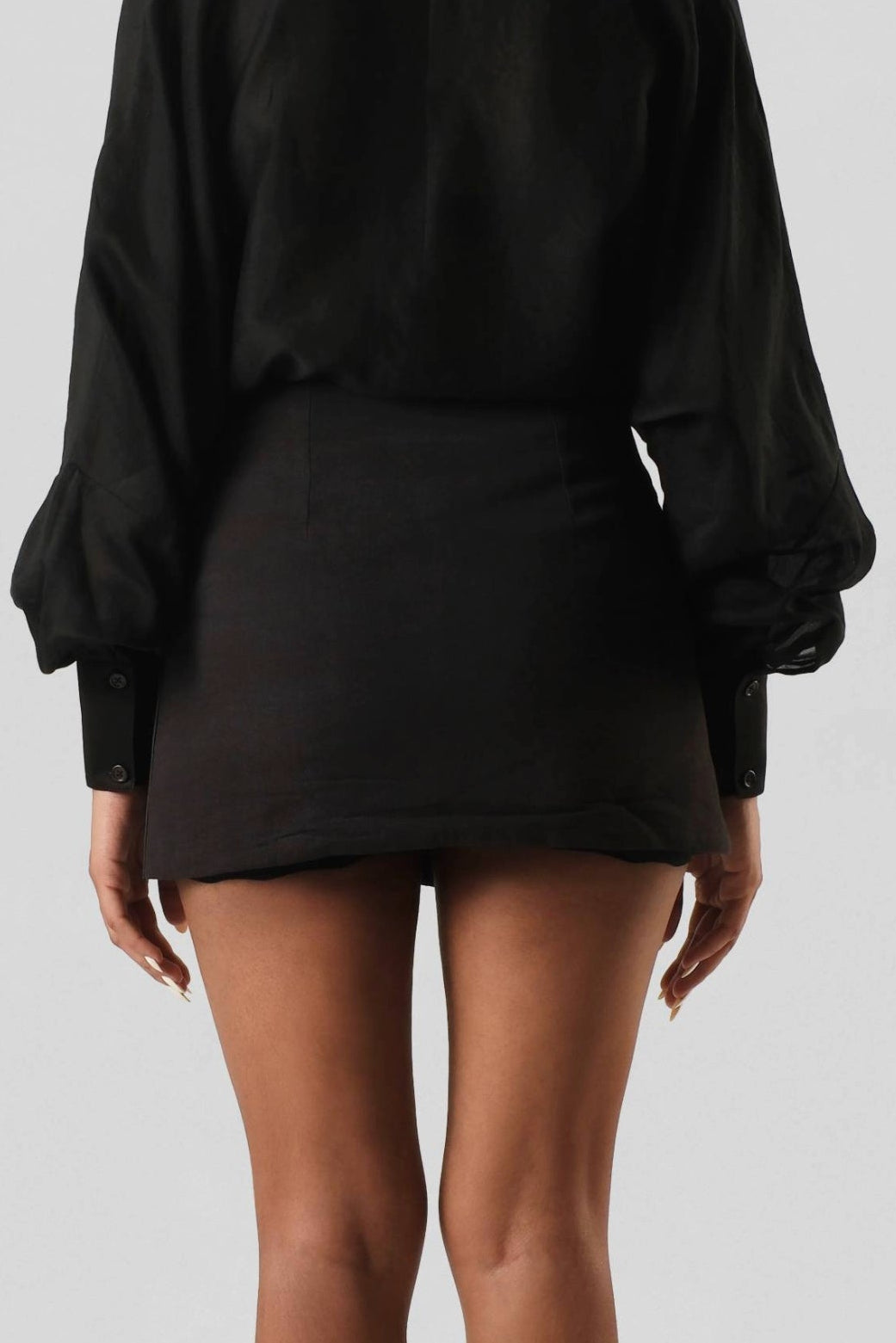 Back view of the RiRi Skirt displaying the clean tailored finish and premium linen with cactus leather detailing.