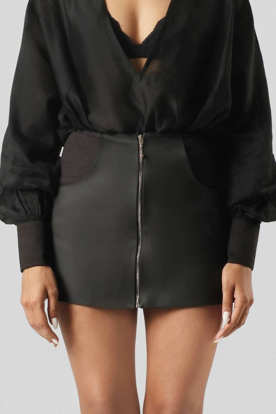 Front full-length view of the RiRi Skirt showcasing its contemporary mini silhouette and structured tailoring.