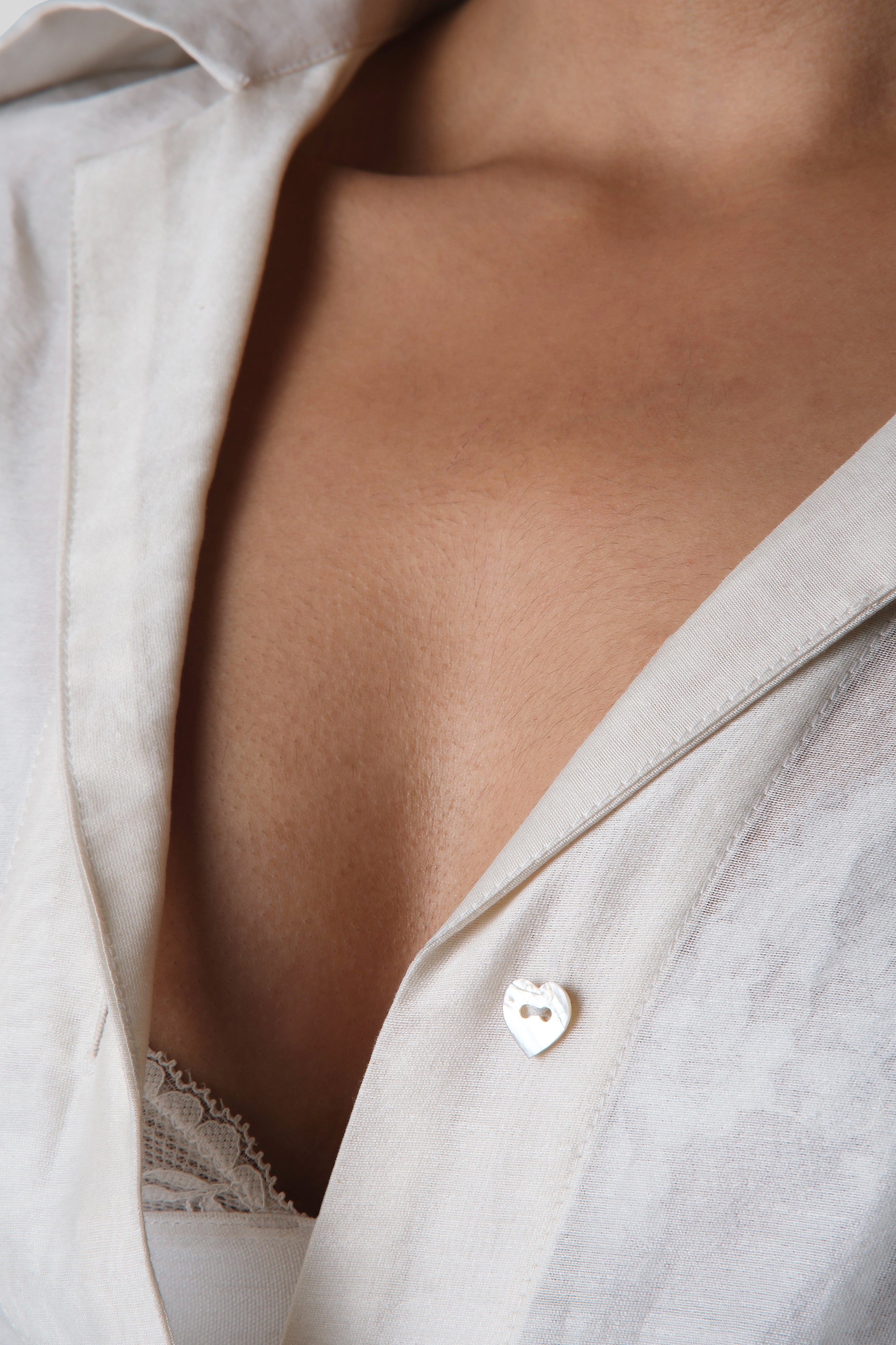 Close-up of the Virginia Shirt collar and heart shaped button placket highlighting refined tailoring and lightweight Chanderi fabric.