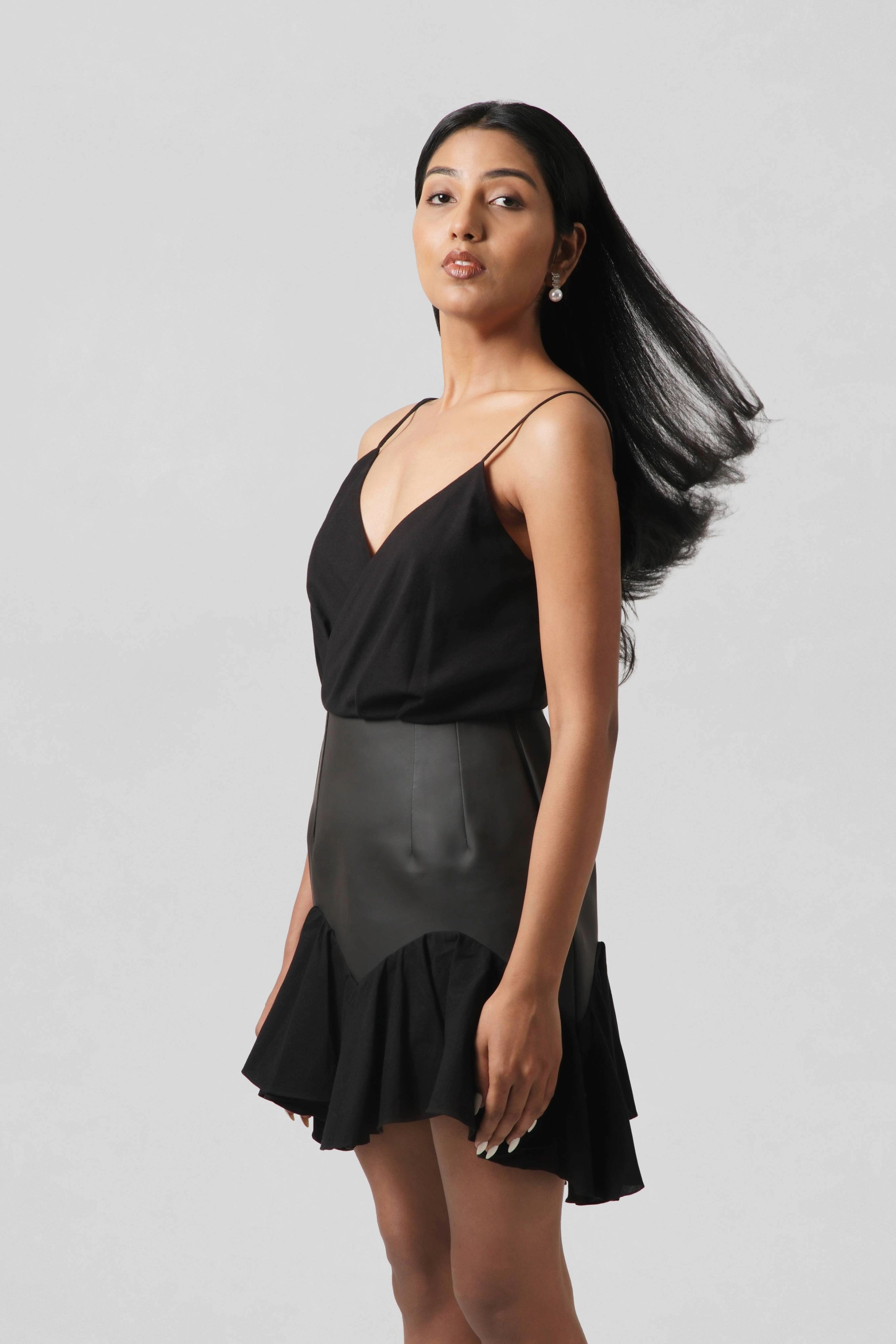 Full-length side view of the Vivienne Dress showing its sculpted silhouette, flowing hem and contemporary luxury design.
