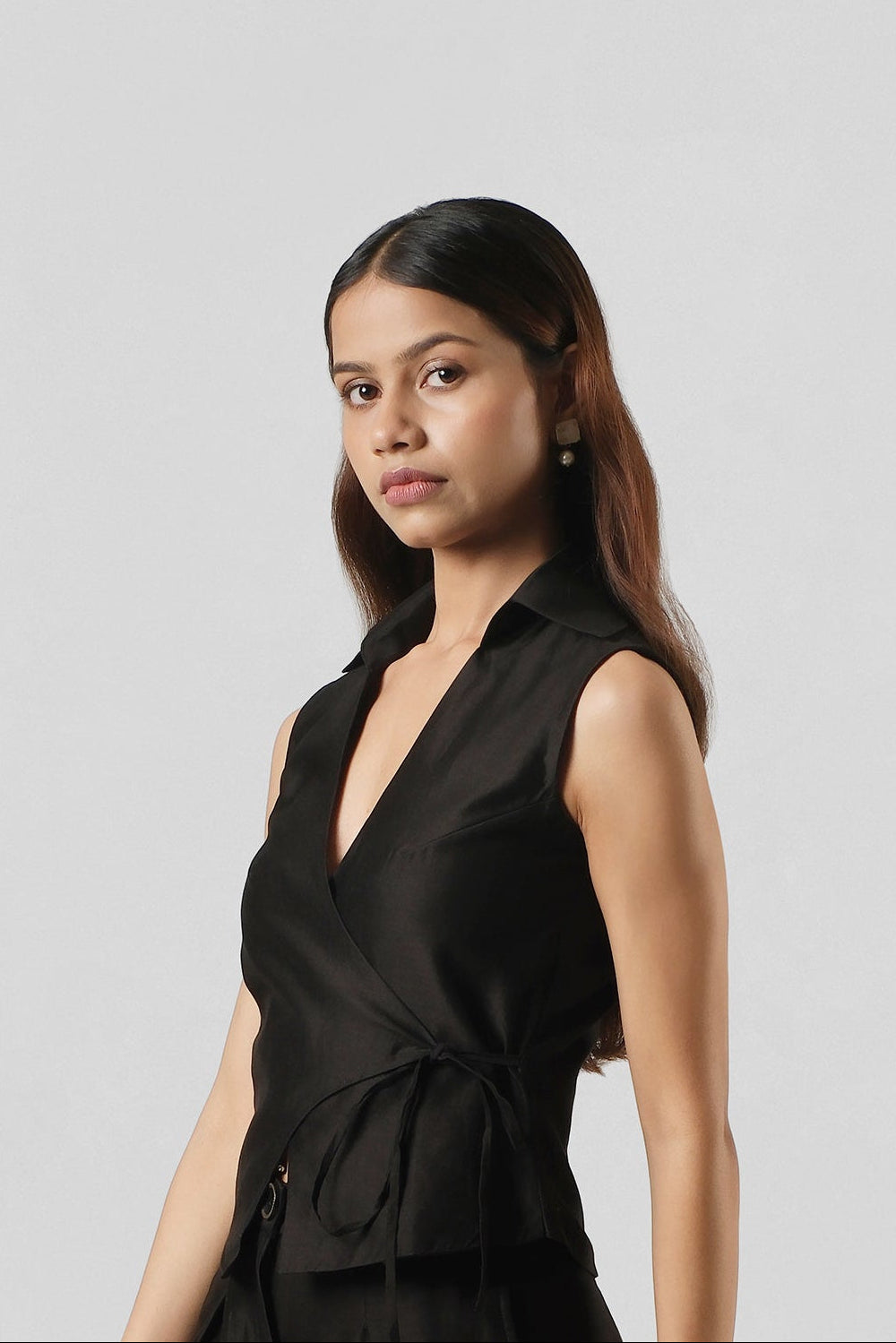 Three-quarter portrait of the Mira Black Co-ord showcasing the sculptural wrap neckline and handcrafted Chanderi fabric.
