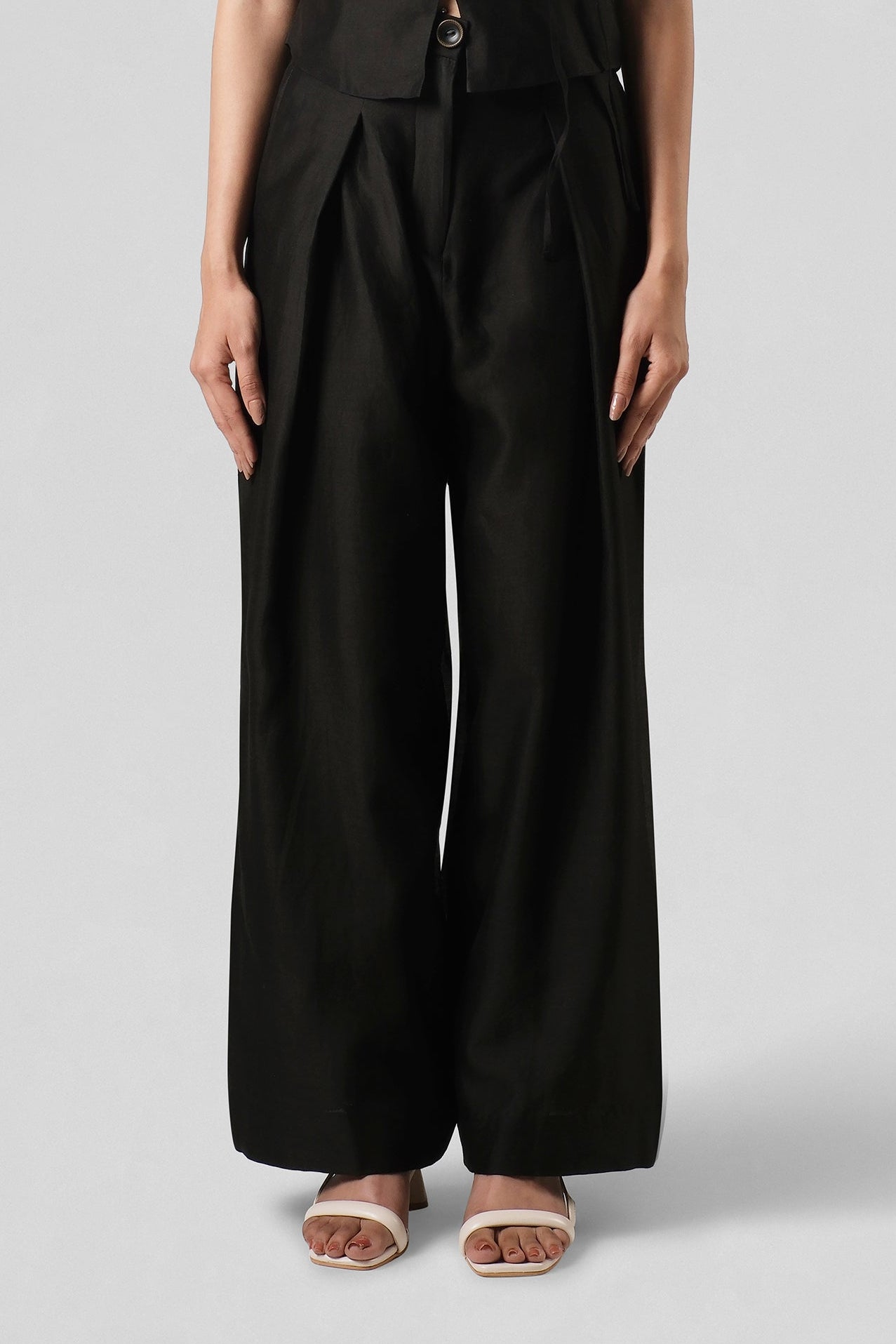 Front view of the Mira Black Wide-Leg Trousers by House of Lore crafted in lightweight Chanderi with a tailored waistband and flowing silhouette.