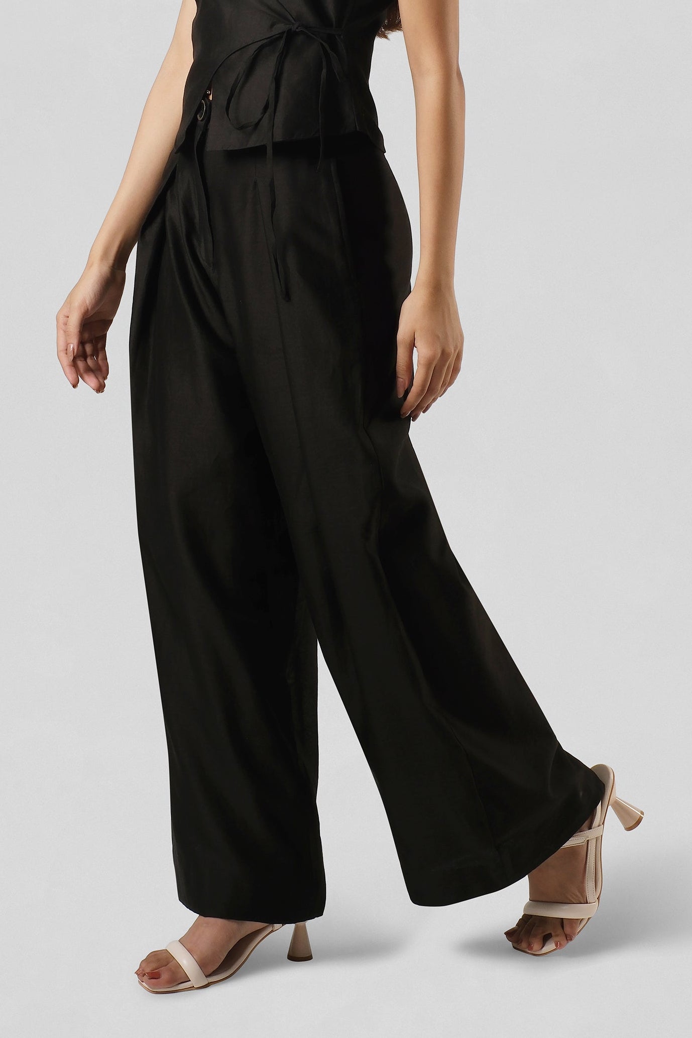 Model wearing the Mira Black Wide-Leg Trousers in handcrafted Chanderi featuring a relaxed fit and elegant drape.