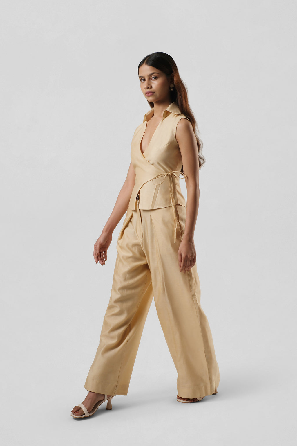 Side view of the Mira Gold Chanderi co-ord highlighting the sculptural wrap silhouette and elegant wide-leg trousers.