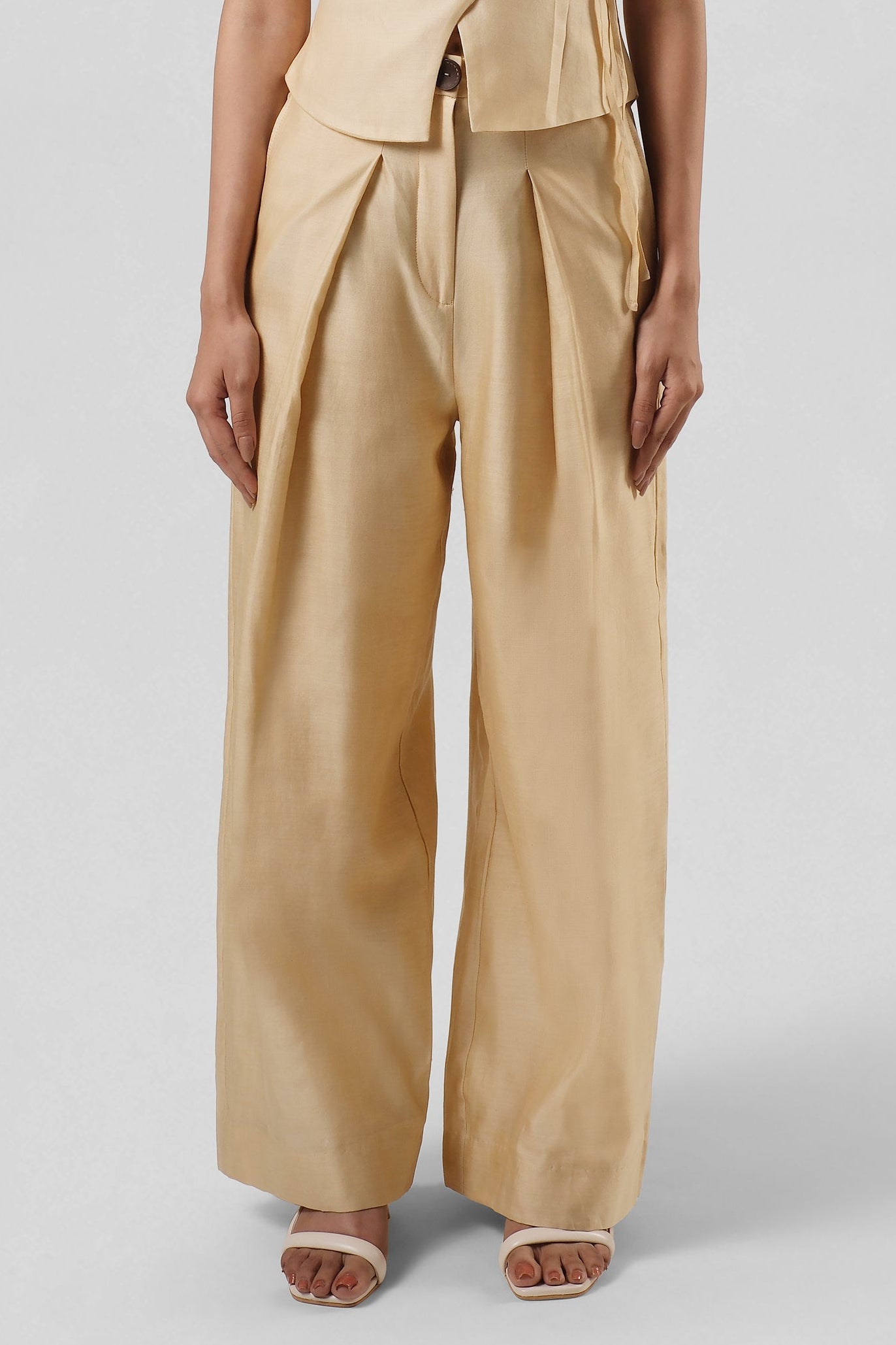 Front view of the Mira Gold Chanderi wide-leg trousers by House of Lore featuring a high-waisted tailored silhouette with fluid movement.