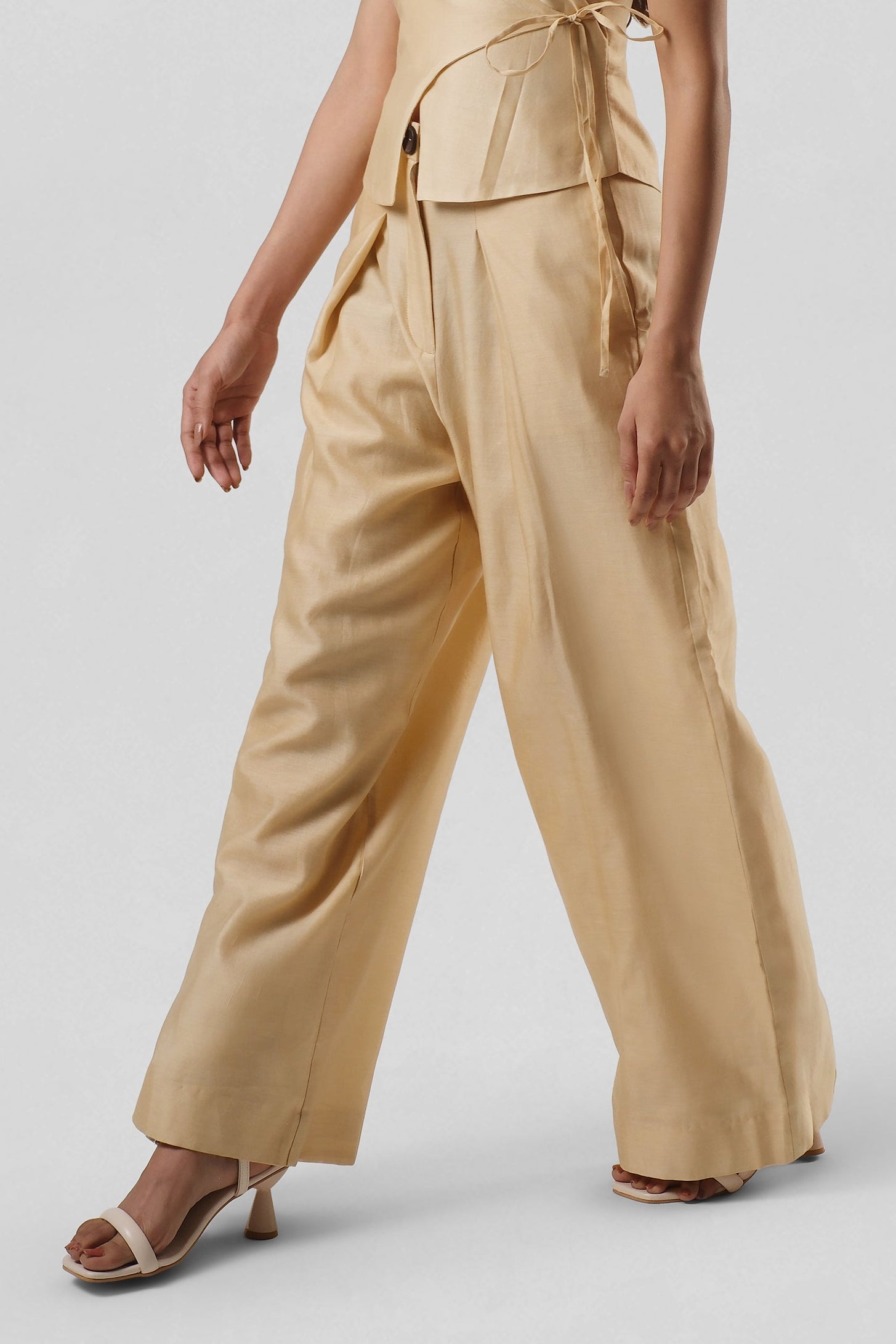 Side view of the Mira Gold Chanderi trousers showcasing the relaxed wide-leg fit and handcrafted drape.