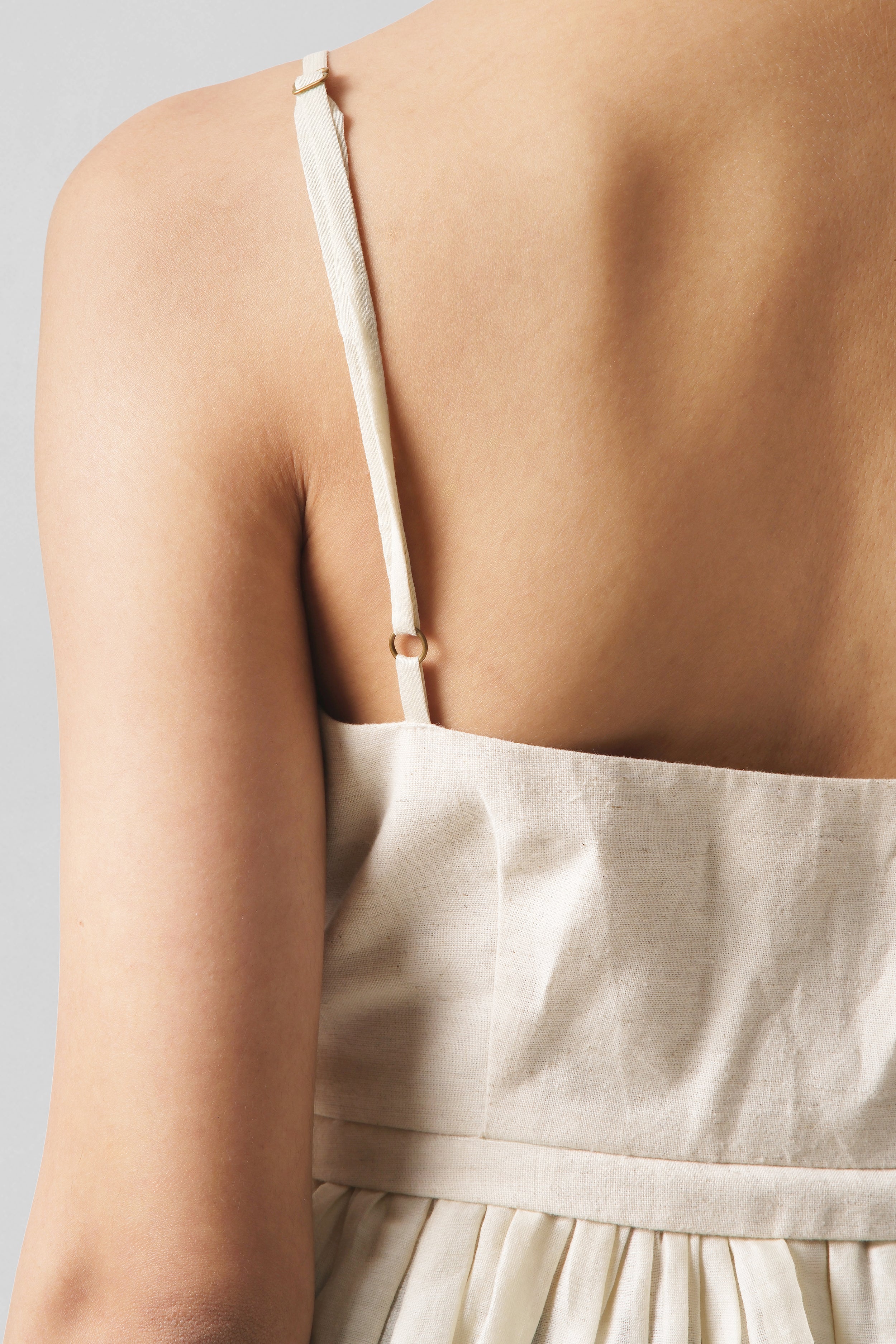 Close-up back detail of the Serena Beige Peplum Top showcasing delicate Chanderi straps and handcrafted linen construction by House of Lore.