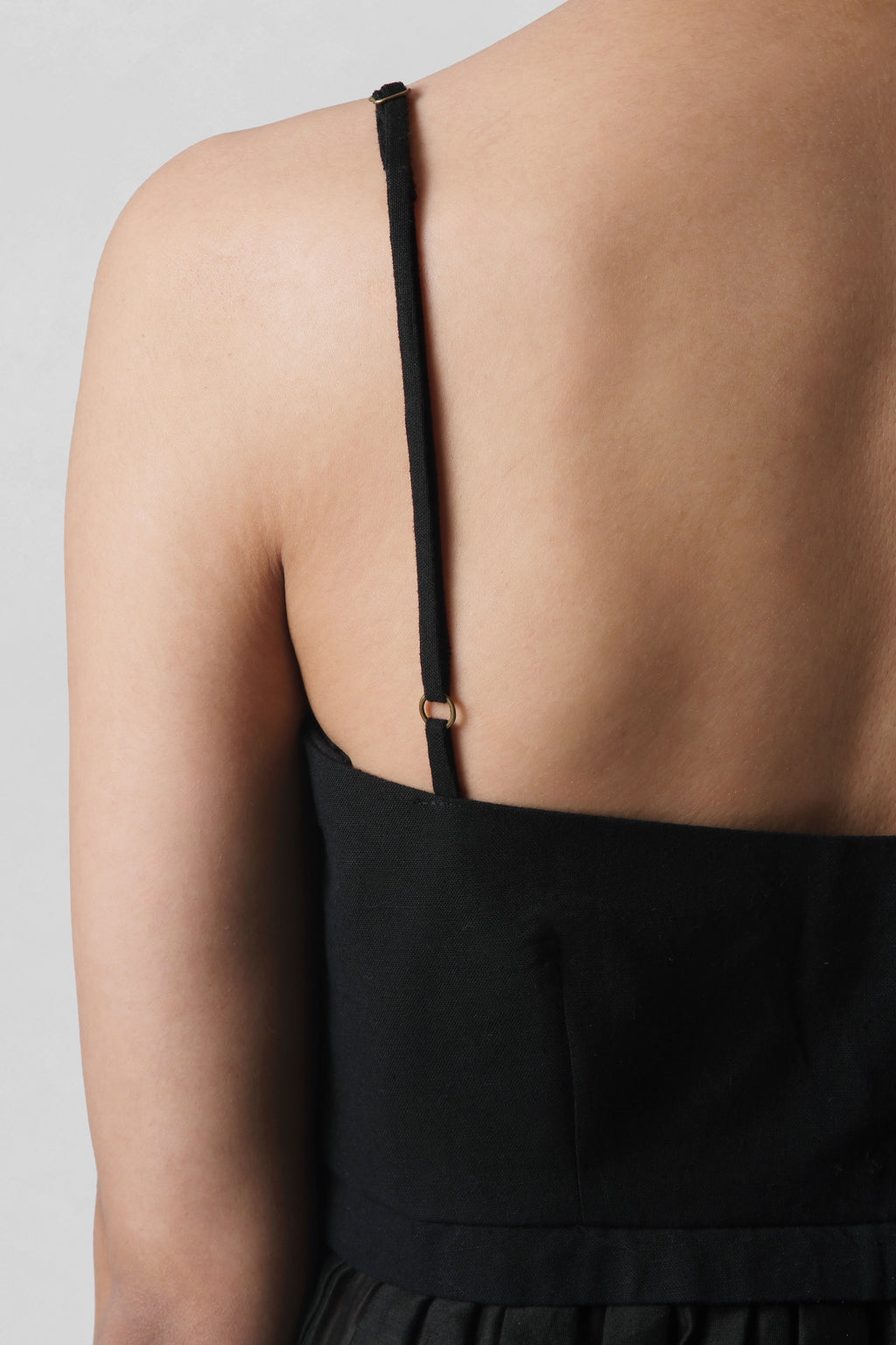 Back view of Serena Black Peplum Top showing delicate Chanderi straps and handcrafted finish