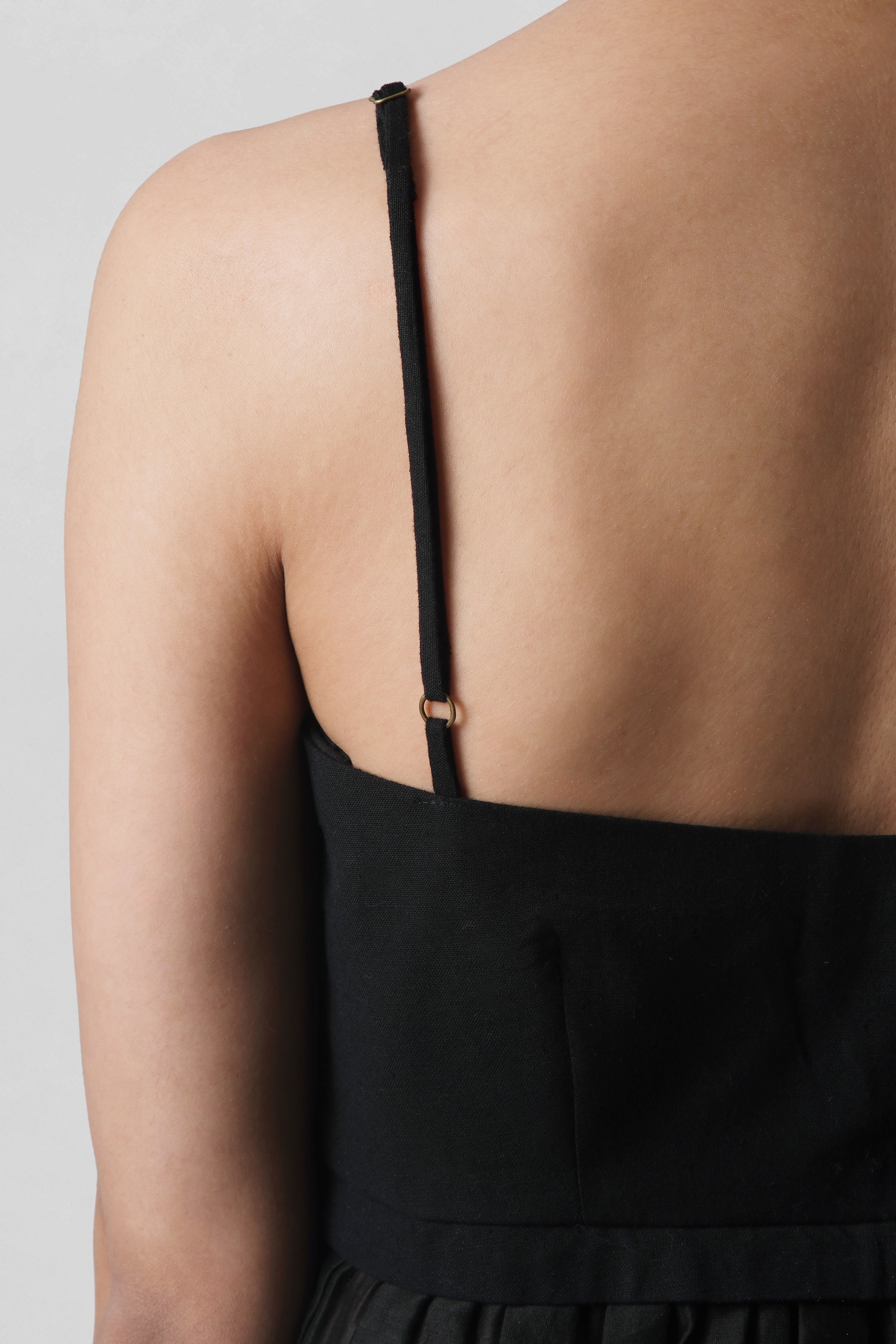 Back view of Serena Black Peplum Top showing delicate Chanderi straps and handcrafted finish